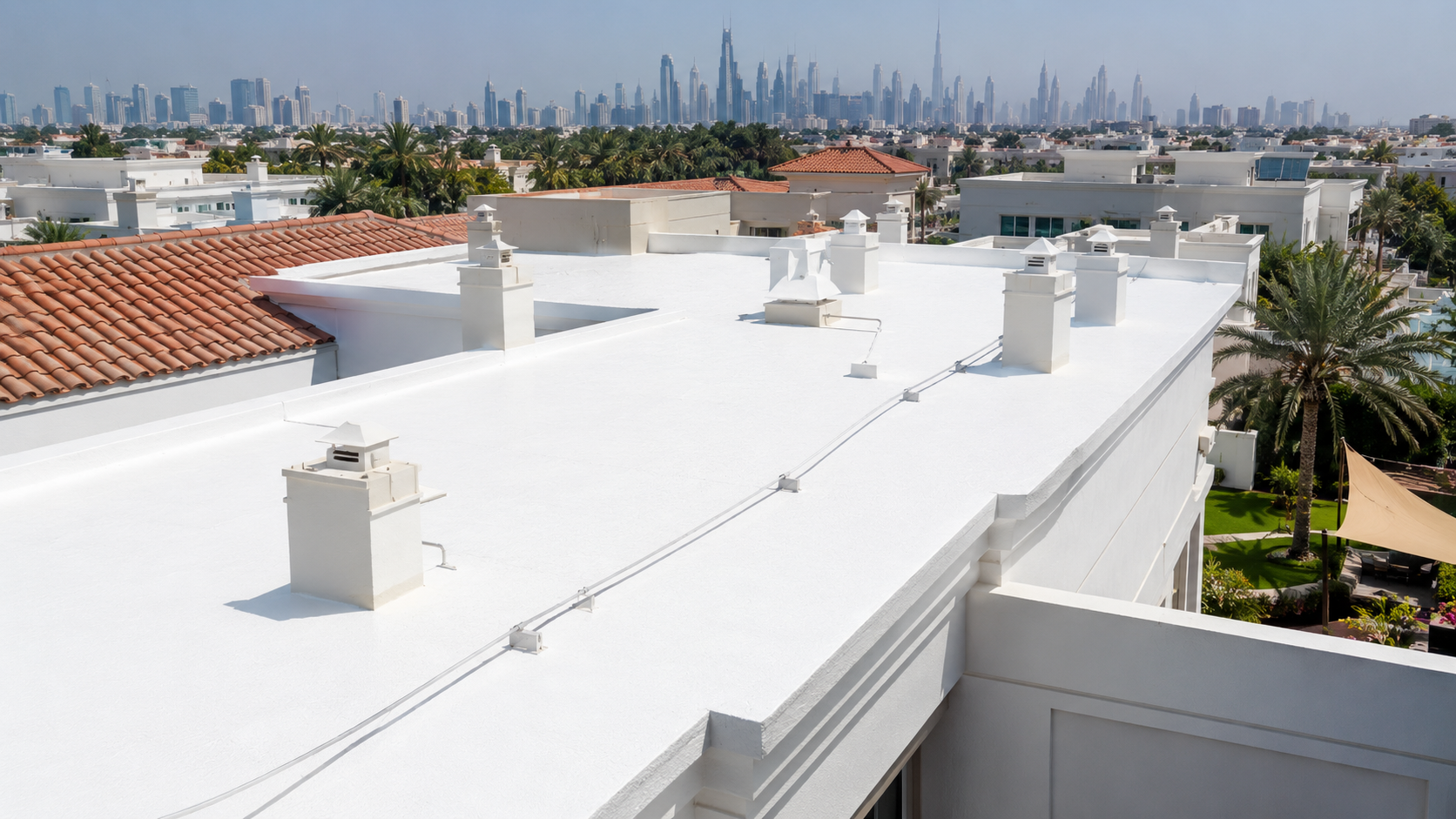 Cool white roof coating on a UAE villa with skyline in the background